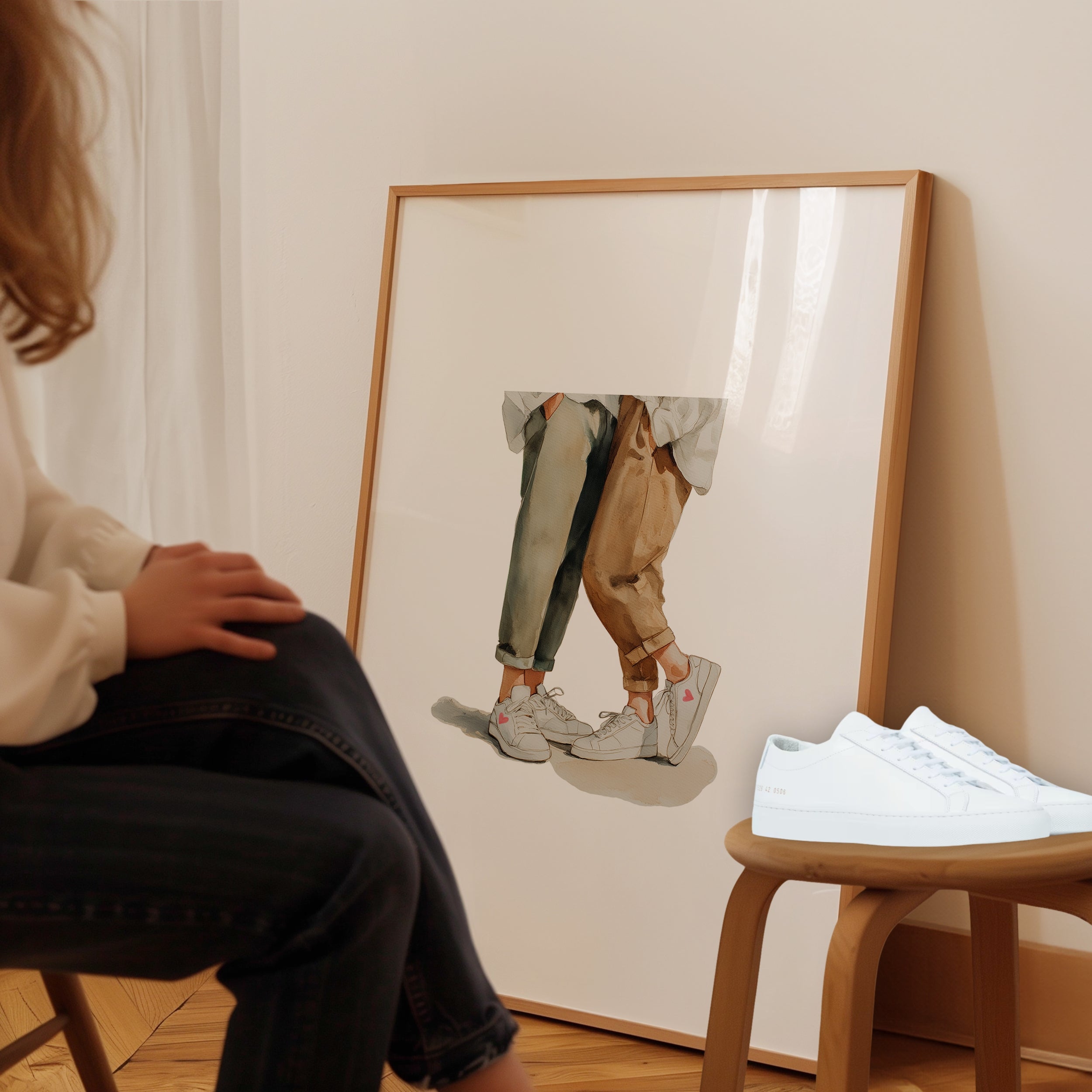 Framed print of two people wearing white sneakers. Purchase for a chance to win white Common Projects Original Achilles Low sneakers.