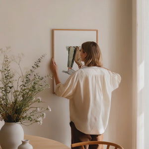 Framed print of two people wearing white sneakers. Purchase for a chance to win white Common Projects Original Achilles Low sneakers.